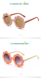 Detail view of flower-shaped children's sunglasses in pink-purple and orange-beige frames