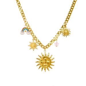 Gold chain necklace with sun, rainbow, and star ceramic pendants on a white background