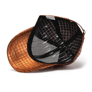 Detail view of the metallic bronze baseball cap with crocodile texture and mesh lining