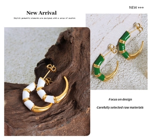 Detail of C-shaped bamboo texture enamel earrings in white and green with gold finish