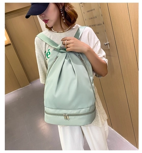 Mint green Oxford fabric backpack with separate dry-wet compartment shown on model