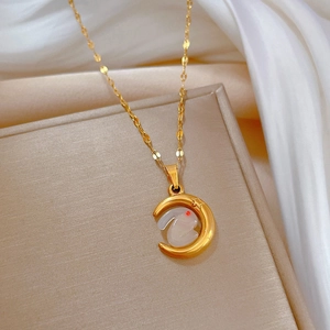 Gold moon and rabbit pendant necklace in titanium steel on soft white silk background