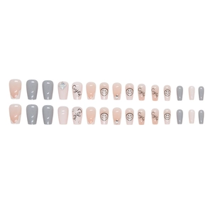 Short star diamond press-on nails with grey and nude pink tones and crystal smiley face