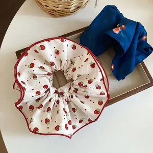 Floral and strawberry print scrunchies in white and navy blue with satin finish