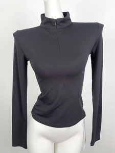 Detail of slim fit dark grey V-neck zip top with padded shoulders and high collar