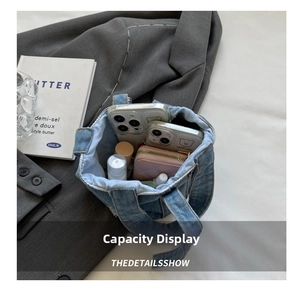 Detail showing the large capacity of this denim bucket bag with daily essentials inside
