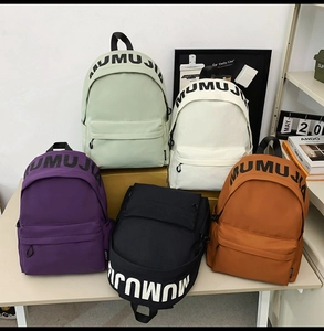Group display of high-capacity backpacks in five trendy colors on a white tabletop