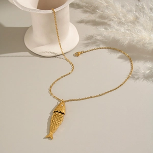 Detailed view of a gold koi fish necklace with scale textures and a small diamond eye