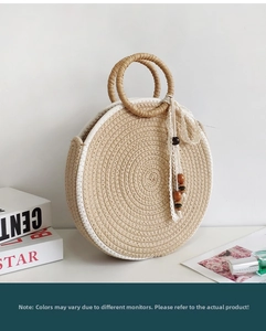 Detail of round straw handbag featuring spiral woven texture and white lace wood bead charm