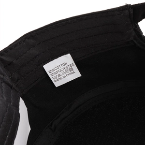 Detail of flat top army cap interior with fabric care label showing cotton blend material