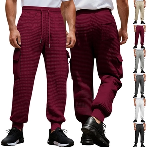 Detail of waffle knit fabric texture and side cargo pockets on men's jogger pants
