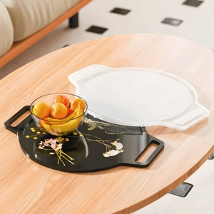 Floral painted round serving tray with handles and translucent lid on wooden table