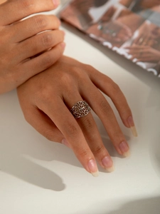 Detailed shot of silver cutout vintage-style titanium steel ring on a model's hand