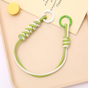 Close-up of hand-woven leather strap keychain with vibrant multi-color contrast design