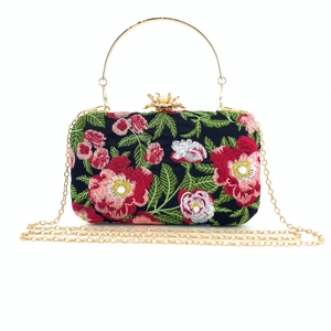 Detailed embroidery and pearl clasp on black floral evening clutch bag with metal handle