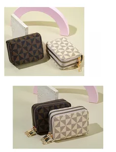 Close-up of double zipper accordion card wallet with geometric triangle pattern and gold hardware