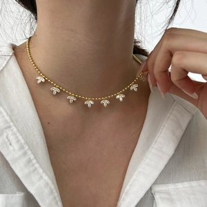 Detailed close-up of a gold S925 silver necklace featuring clover leaf pendants and zircon