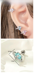 Detailed macro view of heart-shaped Saturn planet stud earrings with shiny zircon stones