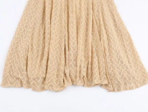 Detailed macro view of the delicate beige lace fabric texture and hollow mesh hemline