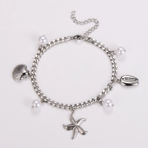 Detailed close-up of stainless steel starfish and seashell charms on a silver bracelet