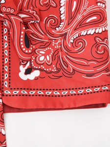 Detail of red paisley print fabric featuring a waist tie and high-quality hem stitching