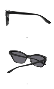 Detail view showing side and back angles of vintage black cat-eye sunglasses with grey lenses