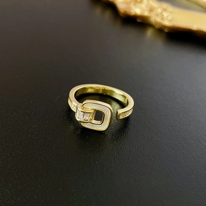 Detail of 18K gold ring featuring mother of pearl inlay and rectangular baguette zircon