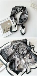 Detail of silk square scarf featuring black white leopard print and floral pattern texture