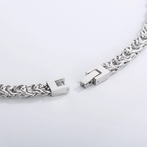 Macro shot of silver hip-hop chain with square buckle detail and polished steel texture