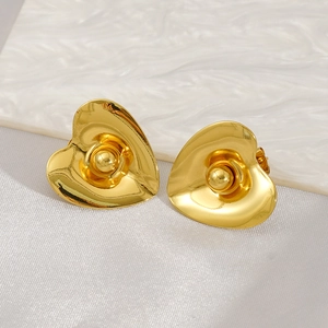 Macro detail of gold-plated titanium steel heart earrings with 3D wave design and center bead