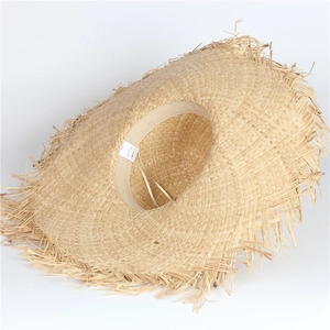 Detailed macro view of the interior woven raffia texture and frayed edge of the sun hat