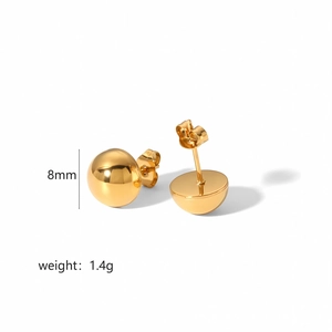Macro shot of 8mm 18K gold ball earrings showing high-polish finish and 1.4g weight