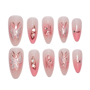 Pink gradient almond press-on nails with rose gold butterfly and rhinestone accents