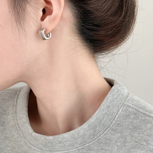 Minimalist square silver hoop earrings with a high-polished mirror finish on a female model