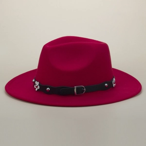 Detail of red fedora hat with black rivet leather belt and white petal flower decoration