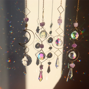 Hanging golden suncatchers with purple natural stones and multi-faceted crystal prisms