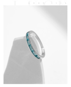 Detailed macro of S925 silver ring featuring blue baguette-cut gemstones in channel setting
