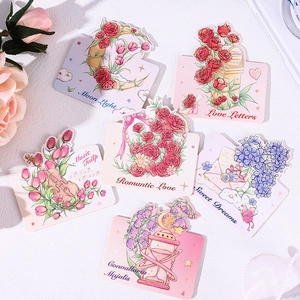 Flat lay of six floral greeting cards with rose, tulip, and violin illustrations