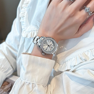 Women's silver quartz watch with rhinestone bezel and metal strap on model wrist