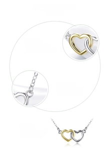 Macro detail of intertwined two-tone 925 sterling silver hearts with 18K gold plating