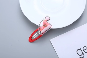 Detail of red Christmas BB clip with transparent hat charm featuring a cute brown bear