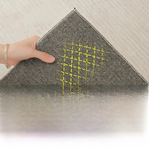 Detail of round rug backing with cotton linen weave and yellow non-slip silicone mesh