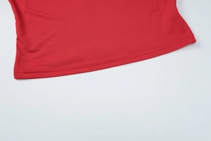 Detailed close-up of double-needle stitching and fabric texture on red skirt set