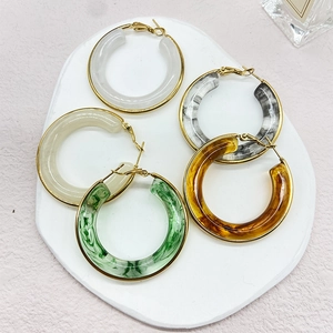 Macro view of assorted resin hoop earrings with 18K gold plated stainless steel accents