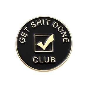 Circular black and gold enamel pin badge featuring GET SHIT DONE CLUB text and checkmark