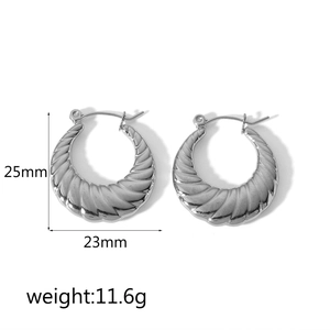 Detail of silver C-shaped hoop earrings with striped texture, 25mm height and 23mm width