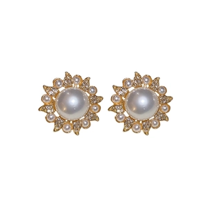 Elegant gold flower stud earrings with large white pearl centers and zircon accents