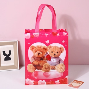 Pink Valentine Bear non-woven gift bag featuring teddy bear and heart patterns with handles