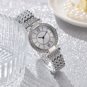 Close-up of a silver diamond-encrusted women's watch with blue hands and Roman numerals