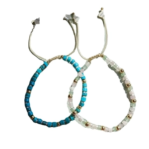 Bohemian stackable beaded bracelets with turquoise, gold beads and star charm on white